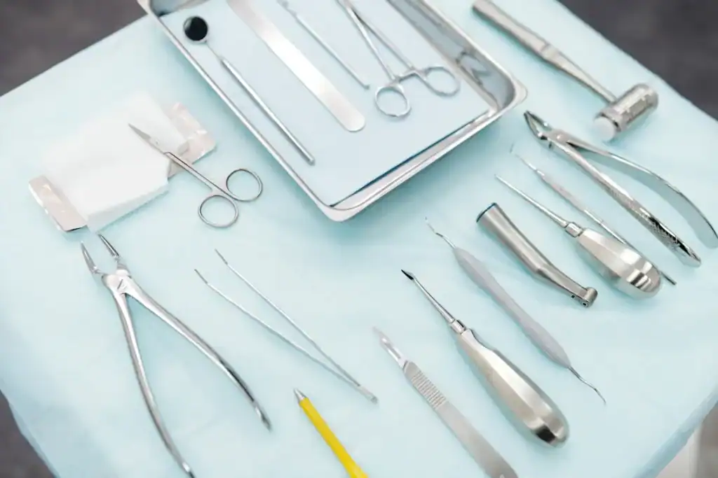 Dental instruments, including extraction forceps, laid out on a sterile cloth