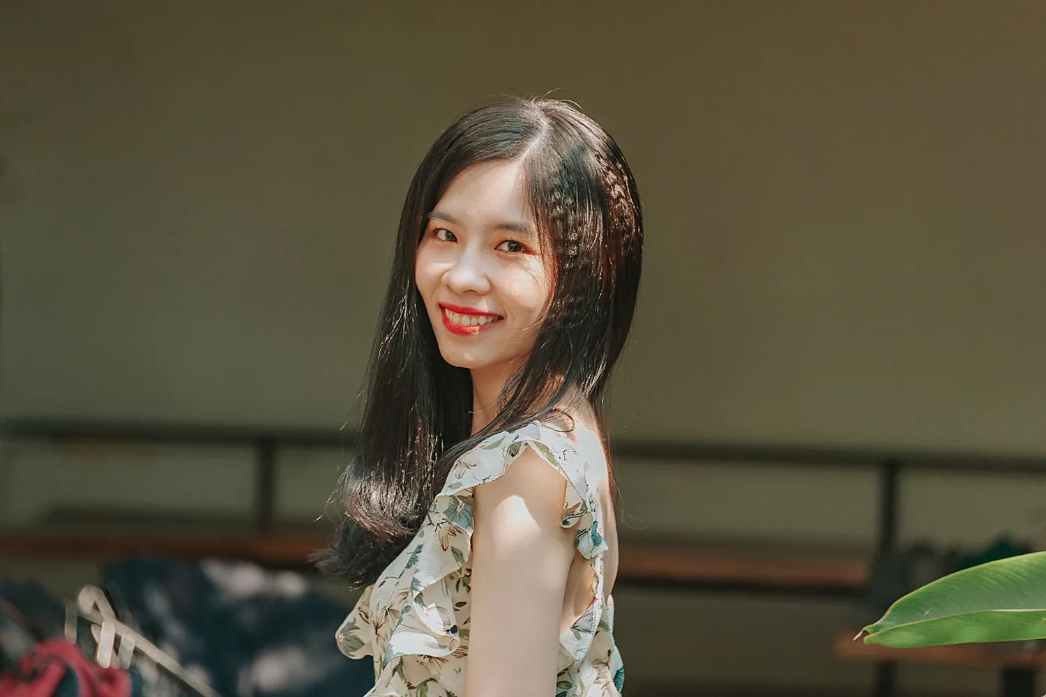 A young Asian woman with a natural, relaxed smile
